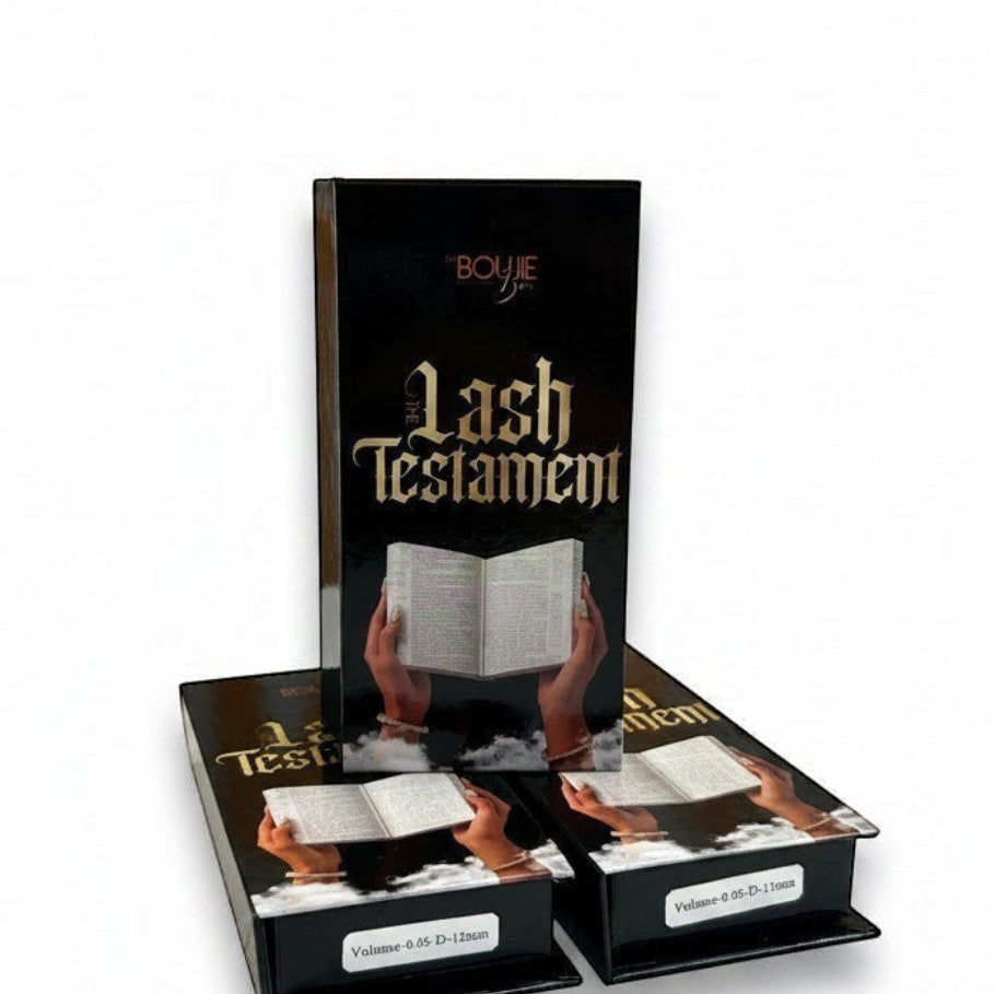 Daboujiebar Lash Testament D Curl lash trays in black packaging with gold lettering. Features open book graphic.