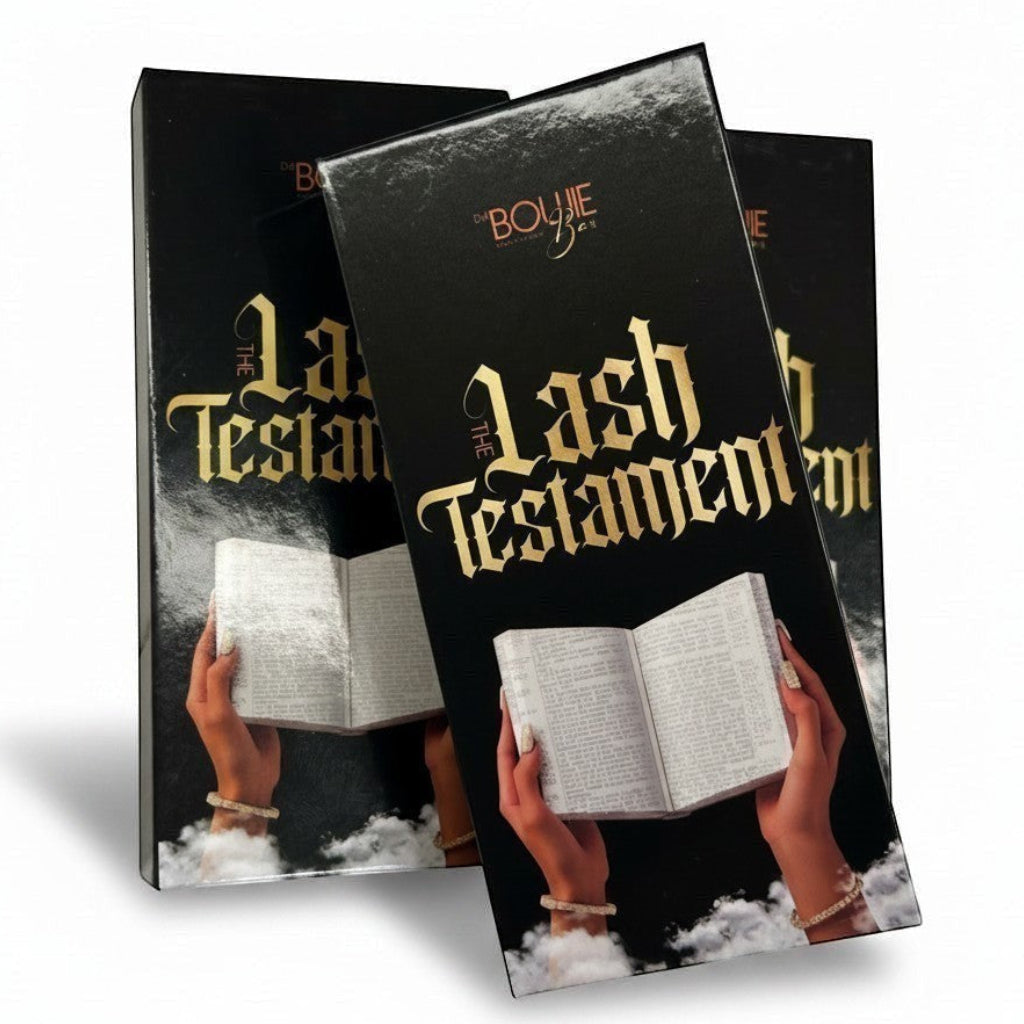 Daboujiebar The Lash Testament D Curl lash trays, designed like a bible, featuring gold lettering and hands holding an open book.